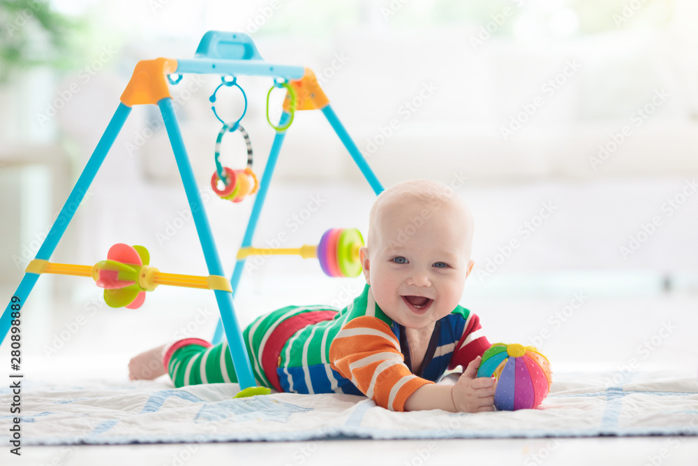 Baby boy with toys and ball - obrazy, fototapety, plakaty 
