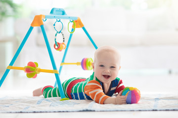 Baby boy with toys and ball