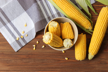 Wall Mural - Fresh corn on a colored background. Corn heads.