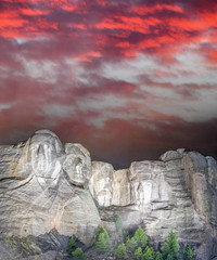 Fototapete - Mt. Rushmore national memorial park in South Dakota at night, presidents faces illuminated against sunset sky