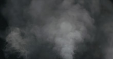 Water Vapor Cloud Comes From Below Over Black Background With Motion Blur
