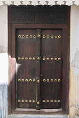 Wall Mural - Old wooden door in Stone Town in Zanzibar island, in the historic center