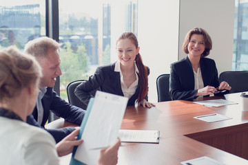 Business people discuss documents