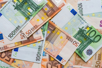 Close up of euro currency, bills of 100 and 50 euros. Concept of finance, business, banking, debt, and European Union.