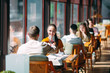 © davit85 - A young couple drinking wine in a restaurant near the window.