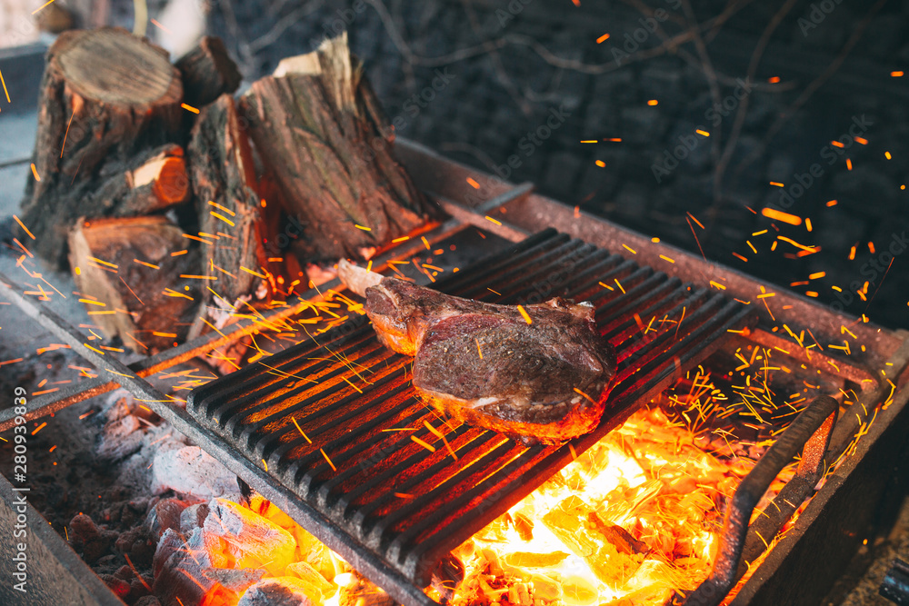 Beef steak is cooked on fire. Beef Rib BBQ . Stock Photo | Adobe Stock