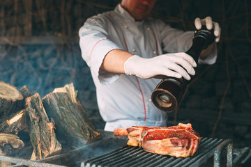 Chef pepper the steak on fire.