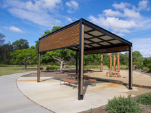 Modern Pergola And Sitting Area With Play Ground Behind In Public Park