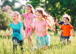 © davit85 - Large group of kids, friends boys and girls running in the park on sunny summer day in casual clothes .
