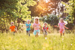 © davit85 - Large group of kids, friends boys and girls running in the park on sunny summer day in casual clothes .