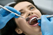 © Andriy Bezuglov - Pretty woman's teeth treatment in dental clinic