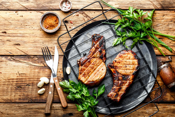 Wall Mural - grilled meat, a portion of two pork loin steaks barbecue