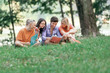 © yurolaitsalbert - friends of students read books sitting on the lawn in the Park