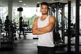 Fototapeta Panele - Fit man standing and relax after the training session in gym,Concept healthy and lifestyle,Male taking a break after exercise and workout