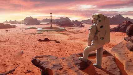 Wall Mural - astronaut on planet mars, looking at a martian colony