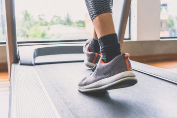 group of young people running on treadmills in modern sport gym