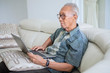 © Creativa Images - Elderly man using a laptop at home