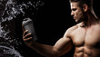 © KDdesignphoto - Model sports young man on dark background. Portrait of beautiful strong muscle guy with gray protein drink in shaker. Water splash.