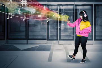 Wall Mural - Hip hop dancer listening music in the MRT station