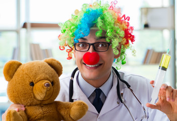 Funny pediatrician with toy in the hospital clinic