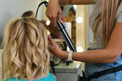 Hairtician Twirls Curls With Flat Iron Hair Back View