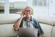 © Creativa Images - Old man listening to music with headphones