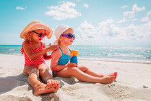 Sun Protection, Cute Girls With Sun Cream At Beach