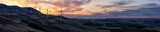 Fototapeta Na ścianę - Beautiful Panoramic Landscape View of Wind Turbines on a Windy Hill during a colorful sunrise. Taken in Washington State, United States of America.