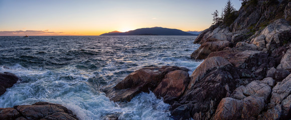 Beautiful Panoramic view of a rocky ocean coast during a vibrant sunny sunset. Taken in Lighthouse Park, Horseshoe Bay, West Vancouver, British Columbia, Canada.