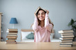 © BestForYou - Smiling student girl at the table with a lot of books. Back to school.