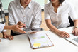 © Prathankarnpap - Young business consult and meeting on work table and digital tablet on hands.