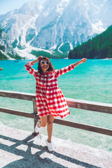 Wall Mural - woman standing in front of lake in mountains