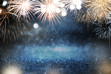 Wall Mural - gold and blue fireworks and bokeh in new year eve and copy space. abstract background holiday.