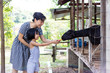 Leinwandbild Motiv Asian Little Chinese Girl and mother feeding a goat with Carrot