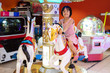 Leinwandbild Motiv Asian Little Chinese Girl playing at amusement