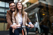 © NDABCREATIVITY - Office woman with business man couple enjoying break while talking flirting outdoor