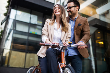 Wall Mural - Office woman with business man couple enjoying break while talking flirting outdoor