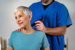 © Microgen - Laser Physical Therapy. Physical Therapist Treating Senior Woman's  Neck