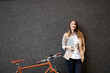 Business woman with bicycle to work on urban street in city. Transport and healthy lifestyle concept