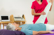 © Microgen - Physical Therapist Working with Leg. Senior Woman
