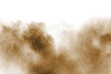 Wall Mural - Freeze motion of brown dust explosion. Stopping the movement of brown powder. Explosive brown powder on white background.