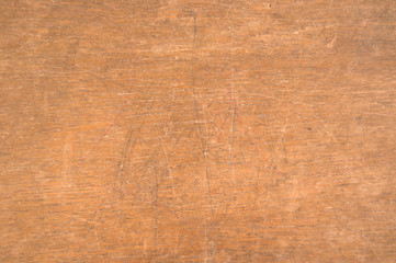 Scratched surface of an old wooden school desk