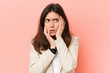 © Asier - Young brunette business woman against a pink background whining and crying disconsolately.