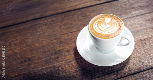 Close up hot cappuccino white coffee cup with heart shape latte art on dark brown old wood table at cafe,food and drink concept Tableau sur Toile