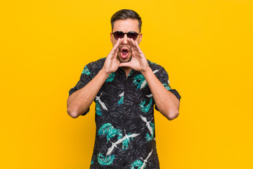 Young filipino man wearing summer clothes shouting excited to front.