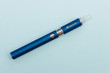 Vape pen metal electronic cigarette with vaping blue background