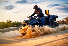Racing Powerful Quad Bike On The Difficult Sand In The Summer.