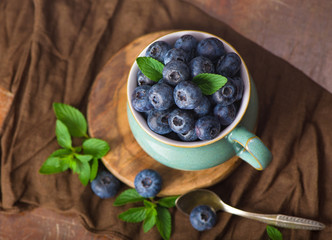 Sticker - Fresh blueberry in a cup with leaves of mint