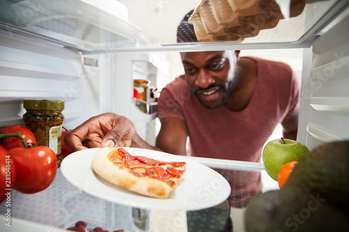 Fotografía View Looking Out From Inside Of Refrigerator As Man Opens Door For Leftover Take