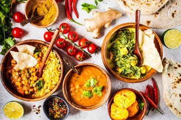 Canvas Print - Food traditional Indian cuisine. Dal, palak paneer, curry, rice, chapati, chutney in wooden bowls on white background.